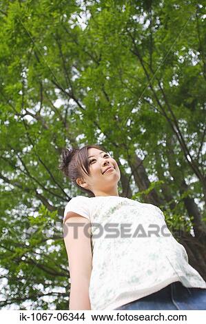 Picture - Young Japanese woman looking away from camera. Fotosearch