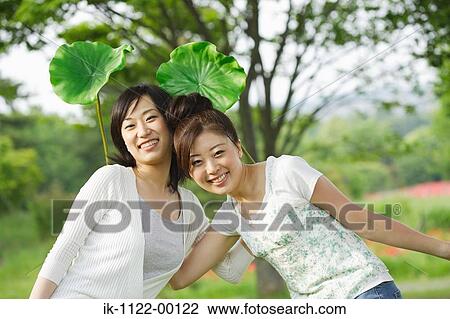 Stock Image - Young smiling women posing for camera shot. Fotosearch