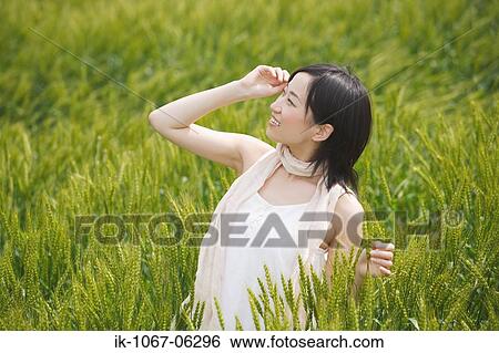 Young smiling women standing in wheat field View Large Photo Image Stock Photograph - Young smiling women standing in wheat field. Fotosearch