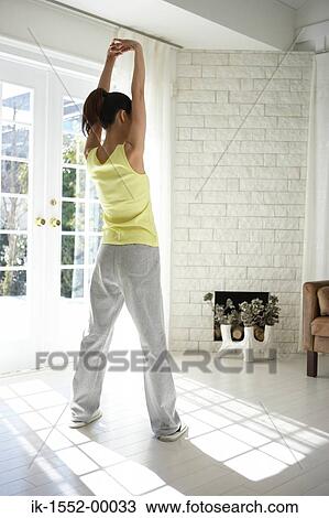 Young woman doing stretching exercise View Large Photo Image Stock Image - Young woman doing stretching exercise. Fotosearch