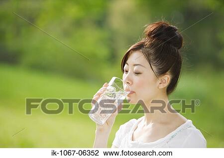 Young woman drinking glass of water View Large Photo Image Stock Image - Young woman drinking glass of water. Fotosearch