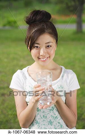Young woman drinking glass of water View Large Photo Image Stock Photo - Young woman drinking glass of water. Fotosearch