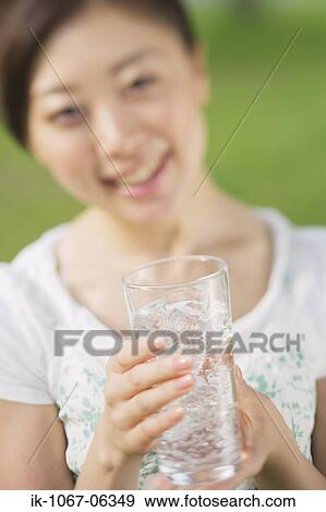 Young woman drinking glass of water View Large Photo Image Stock Photo - Young woman drinking glass of water. Fotosearch