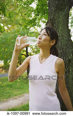 Stock Image - Young Woman Drinking Water. Fotosearch