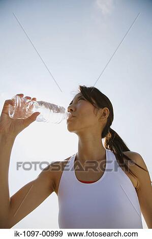 Stock Photo - Young Woman Drinking Water. Fotosearch
