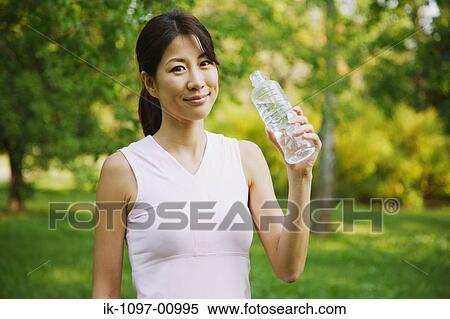 Stock Photography - Young Woman Drinking Water. Fotosearch