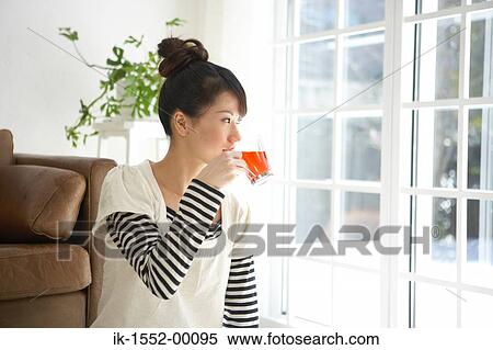 Young woman having herbal tea View Large Photo Image Stock Photography - Young woman having herbal tea. Fotosearch