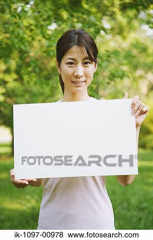 Stock Photo - Young Woman Holding a Sign. Fotosearch