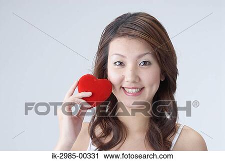 Stock Image - Young Woman Holding Heart. Fotosearch