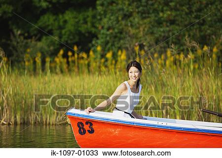 Stock Image - Young Woman in Boat. Fotosearch