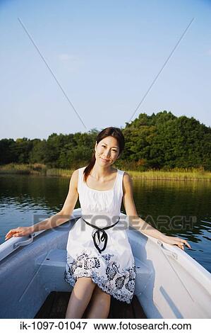 Stock Photo - Young Woman in Boat. Fotosearch