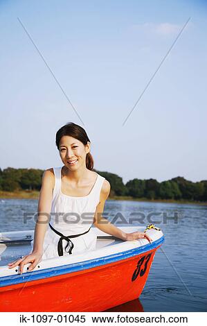 Stock Photography - Young Woman in Boat. Fotosearch