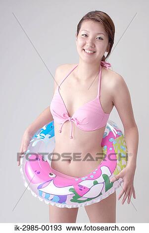Stock Image - Young Woman in Rubber Ring. Fotosearch