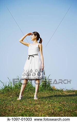 Stock Image - Young Woman in Summer Dress. Fotosearch