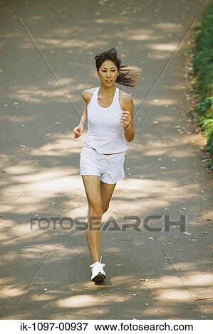 Stock Photo - Young Woman Jogging. Fotosearch