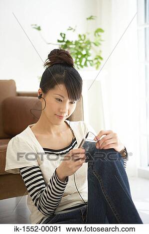 Young woman leaning and listening music View Large Photo Image Stock Image - Young woman leaning and listening music. Fotosearch