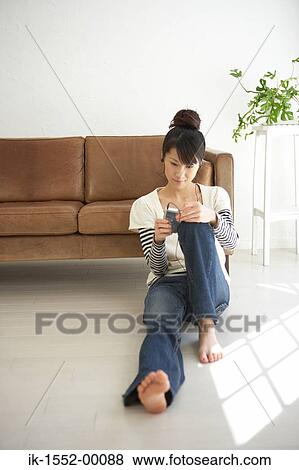 Young woman leaning by sofa and listening music View Large Photo Image Stock Photo - Young woman leaning by sofa and listening music. Fotosearch
