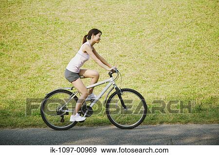 Young Woman Riding a Bicycle View Large Photo Image Stock Photo - Young Woman Riding a Bicycle. Fotosearch