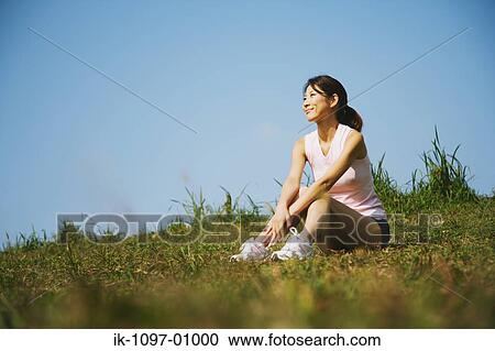 Young Woman Sitting Down on Grassy Hill View Large Photo Image Stock Image - Young Woman Sitting Down on Grassy Hill. Fotosearch