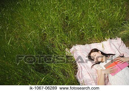 Stock Photo - Young woman sleeping with book. Fotosearch