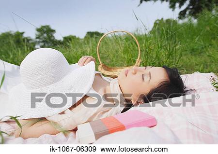 Stock Photo - Young woman sleeping with book. Fotosearch