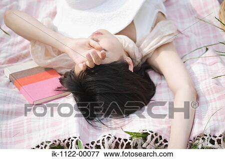 Young woman sleeping with book View Large Photo Image Stock Photo - Young woman sleeping with book. Fotosearch