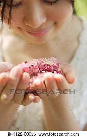 Young woman smelling flowers View Large Photo Image Stock Photography - Young woman smelling flowers. Fotosearch