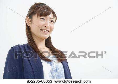 Stock Image - Young woman smiling and looking up. Fotosearch