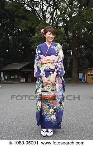 Young woman smiling in kimono dress View Large Photo Image Stock Image - Young woman smiling in kimono dress. Fotosearch