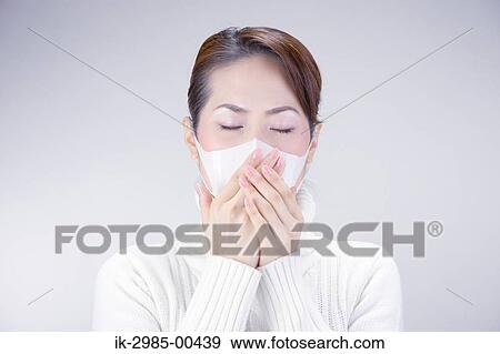 Stock Photo - Young Woman Wearing Face Mask. Fotosearch