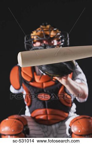 Picture - A baseball bat in front of a baseball umpire. Fotosearch