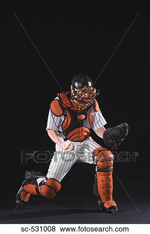 Stock Photo - A baseball catcher cheering. Fotosearch