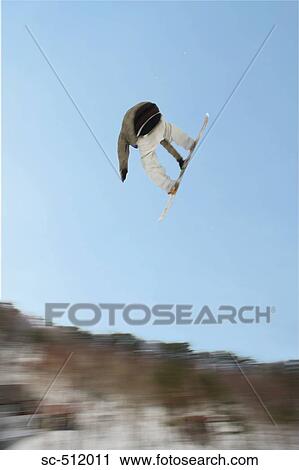 Stock Image - Airborne snowboarder. Fotosearch