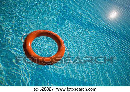 An orange life ring floating in water View Large Photo Image Stock Photo - An orange life ring floating in water. Fotosearch