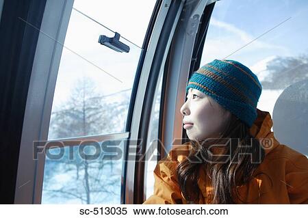 Asian female snowboarder in ski lift View Large Photo Image Stock Photography - Asian female snowboarder in ski lift. Fotosearch