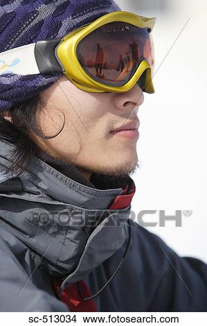 Picture - Asian male snowboarder. Fotosearch