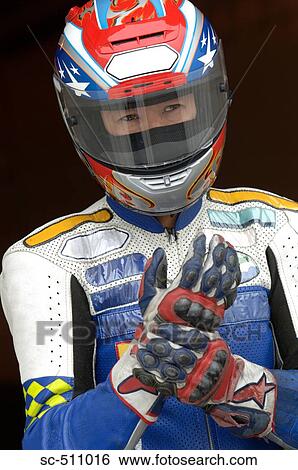 Asian racing motor biker anticipating race View Large Photo Image Stock Photograph - Asian racing motor biker anticipating race. Fotosearch