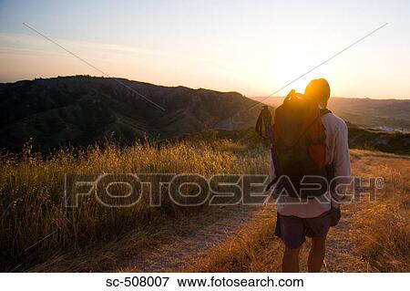 Stock Photo - Backpacker on path. Fotosearch