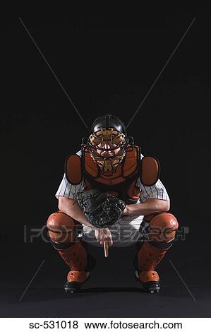 Stock Photo - Baseball catcher giving hand signals. Fotosearch