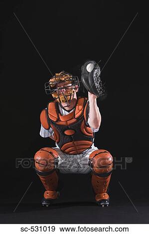 Stock Photo - Baseball catcher holding ball in mitt. Fotosearch