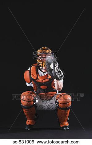 Stock Photograph - Baseball catcher holding ball in mitt. Fotosearch