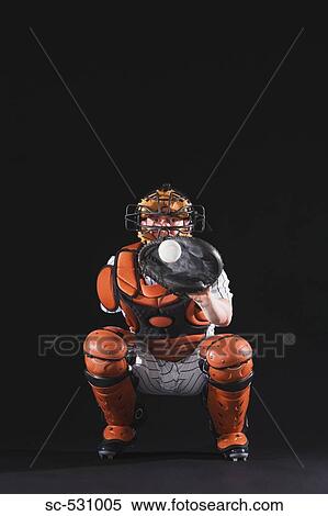 Stock Photography - Baseball catcher holding ball in mitt. Fotosearch