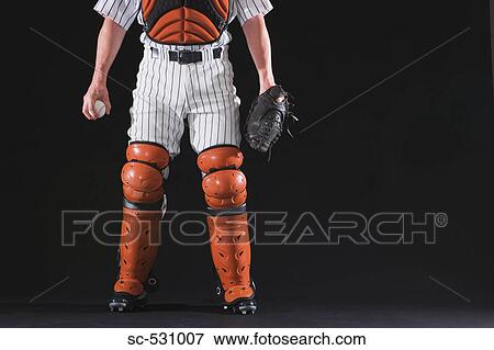 Stock Photo - Baseball catcher with black background. Fotosearch