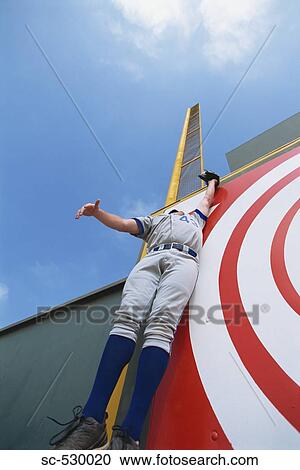 Stock Image - Baseball Player Reaching for Ball. Fotosearch