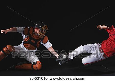 Stock Image - Baseball player sliding into a base. Fotosearch