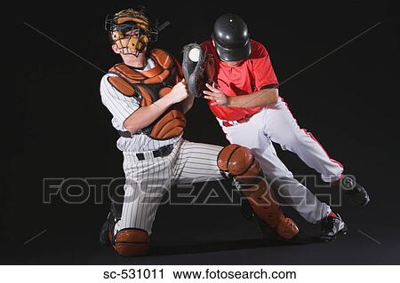Stock Image - Baseball player sliding into a base. Fotosearch