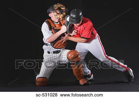 Stock Photo - Baseball player sliding into a base. Fotosearch