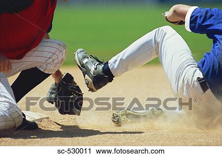 Stock Image - Baseball Players Sliding into Base. Fotosearch