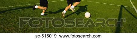 Stock Photo - Boy dribbling away. Fotosearch