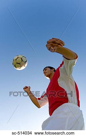 Picture - Boy juggling Soccer ball. Fotosearch
